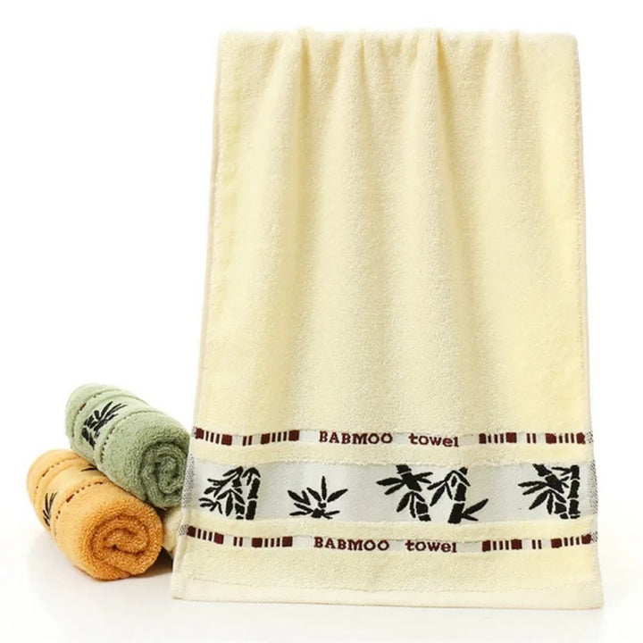 Bamboo bath towel set: cream towel with printed band and rolled towels