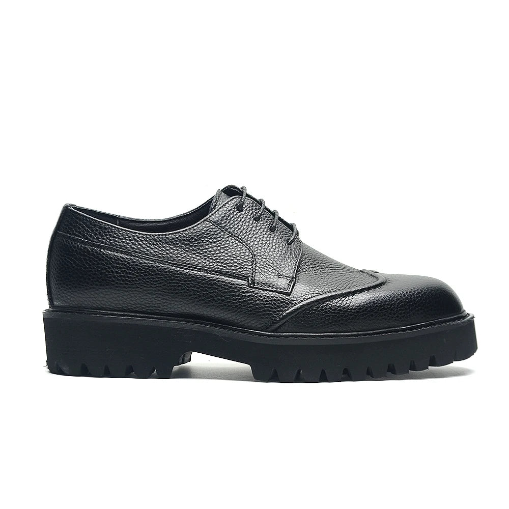 Black leather shoe with a thick sole on a white background