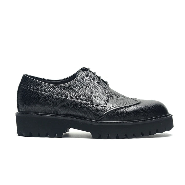 Black leather shoe with a thick sole on a white background