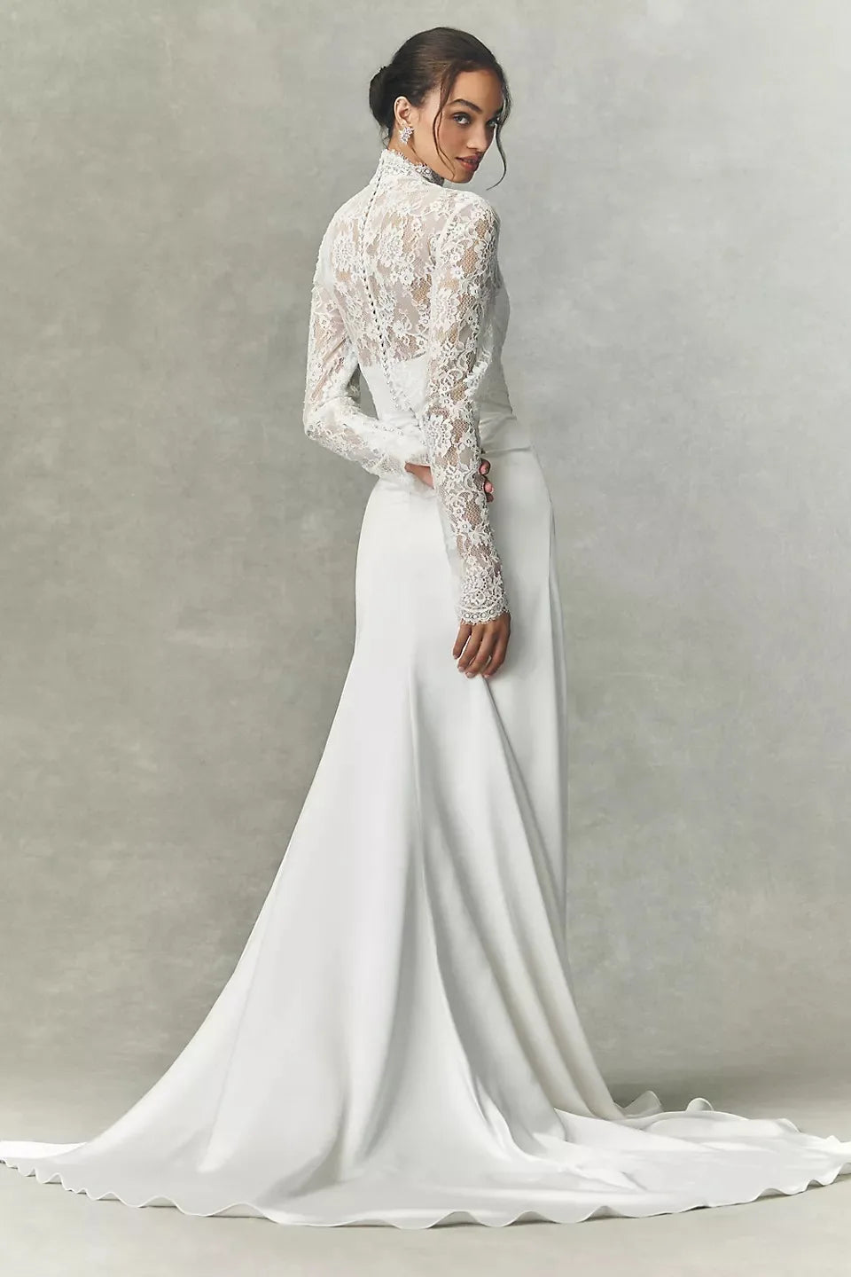 White lace high-neck bridal jacket with long sleeves worn with satin mermaid skirt, full view
