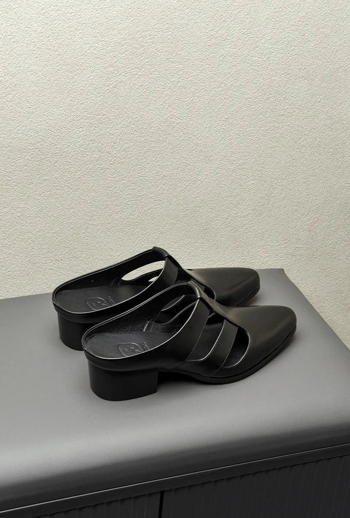 Black sandals on a gray surface with text 'MY HOBBY IS OUTSTANDING' above.