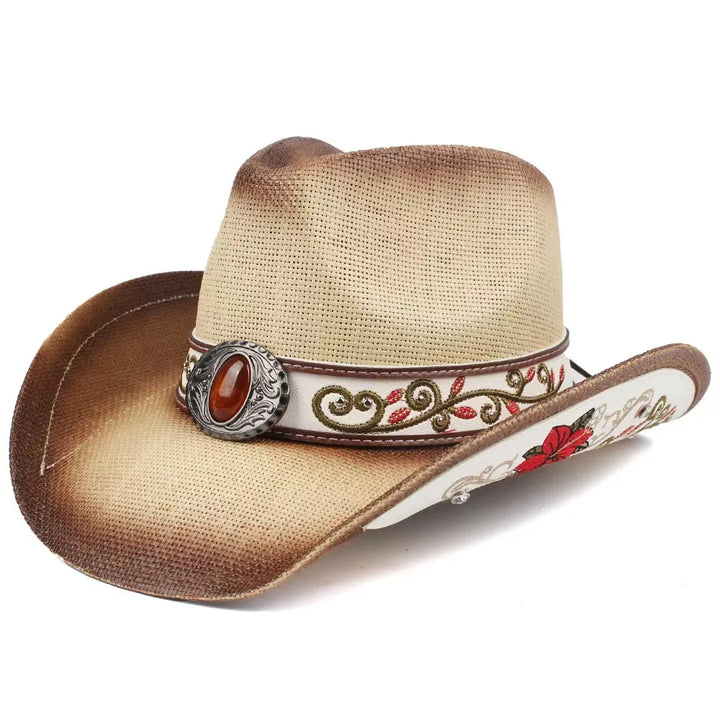 Beige cowboy hat with decorative band, silver buckle, and red oval centerpiece