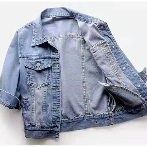 Light blue denim jacket with buttoned flap chest pockets and three-quarter sleeves