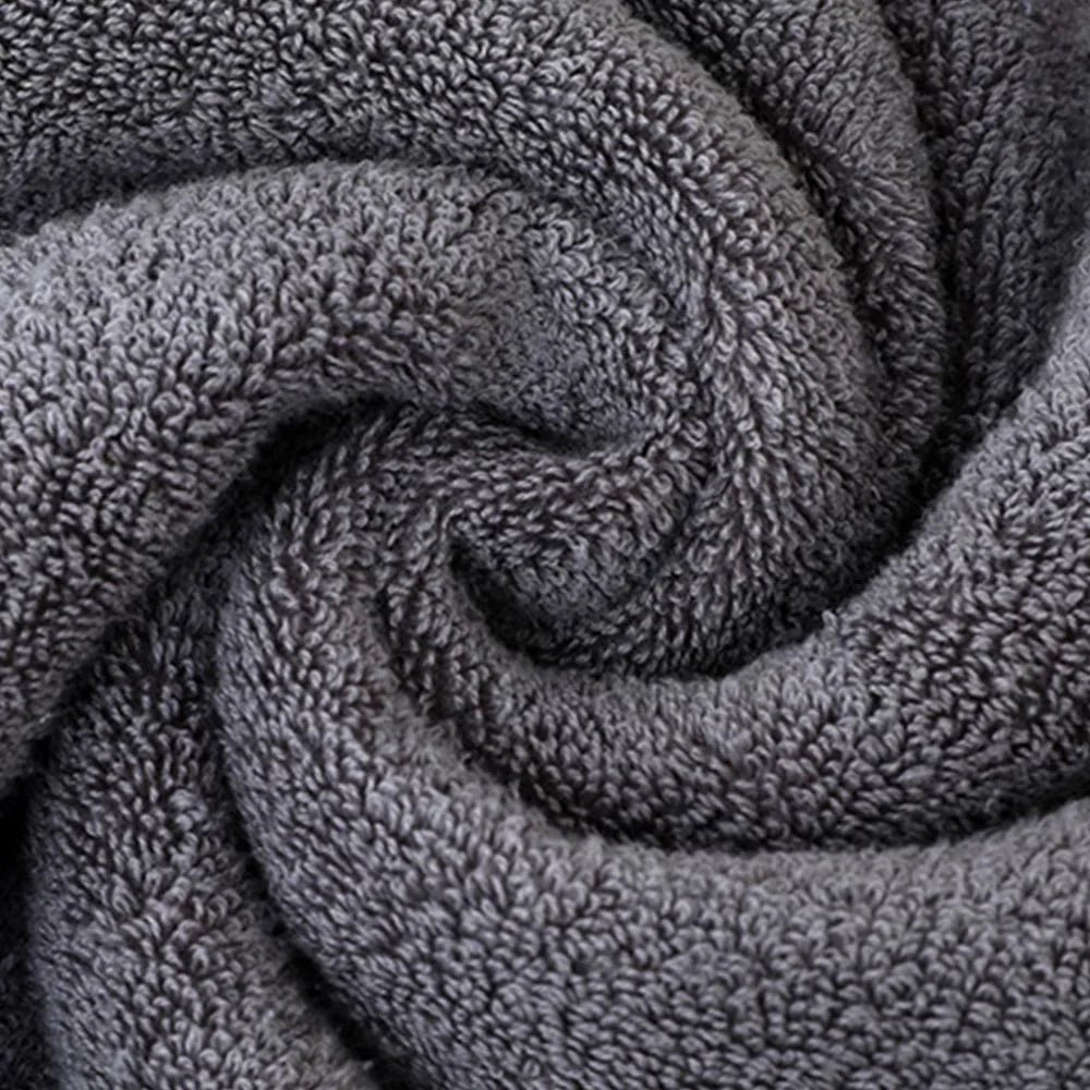 Gray terry hand towel fabric texture with dense looped pile, close-up