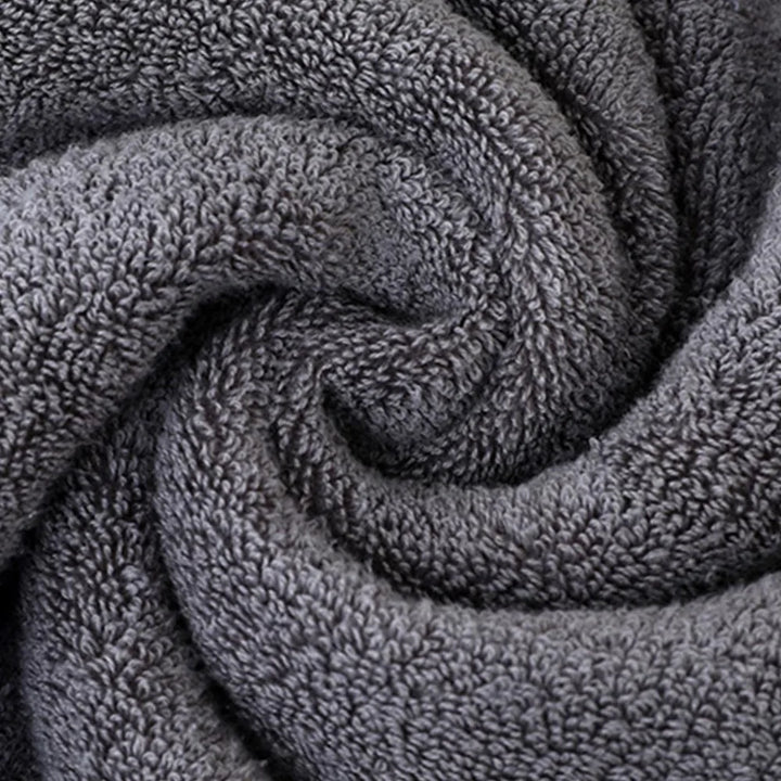 Gray terry hand towel fabric texture with dense looped pile, close-up