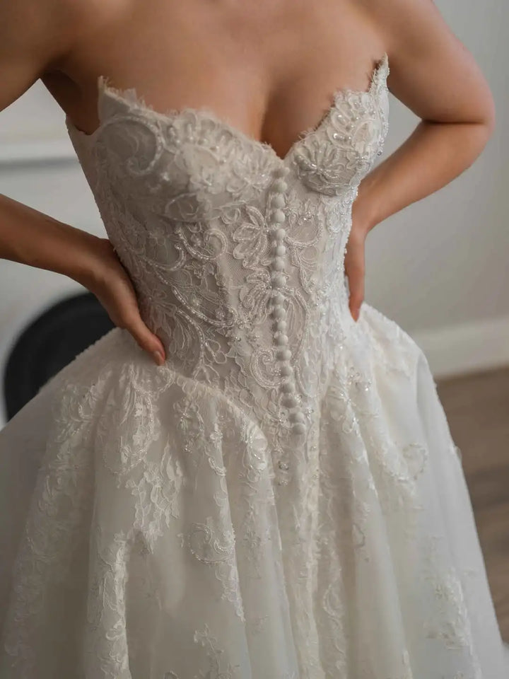 Lace bridal gown with corset bodice, sweetheart neckline, and A-line skirt