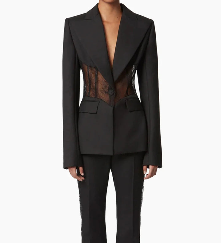 Black sheer lace panel blazer worn by model with notch lapels and flap pockets