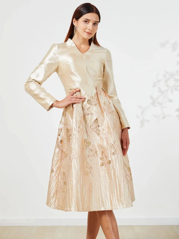 Woman wearing a beige dress with floral patterns on a white background