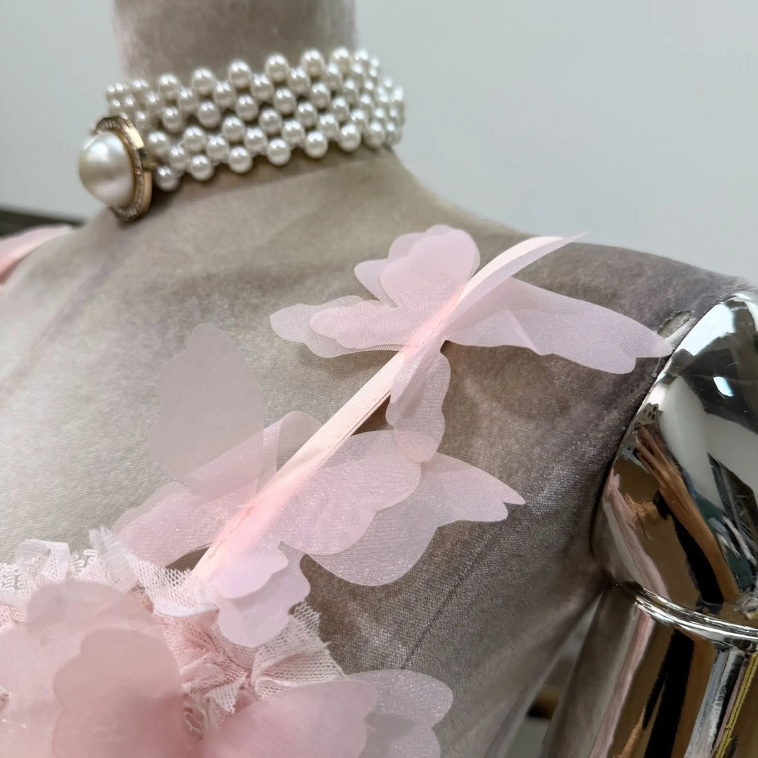 Pink corset mini dress back detail with pearl choker and flower appliques