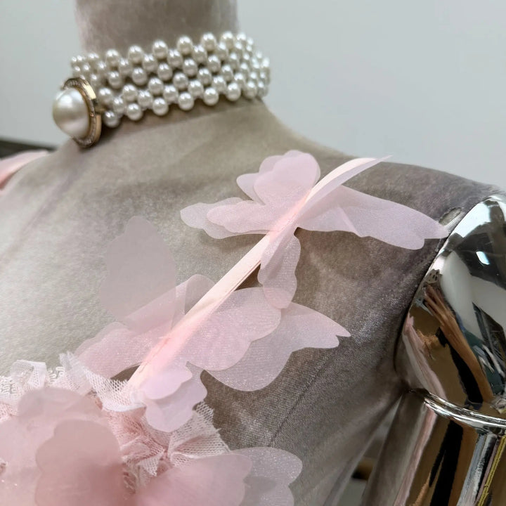 Pink corset mini dress back detail with pearl choker and flower appliques