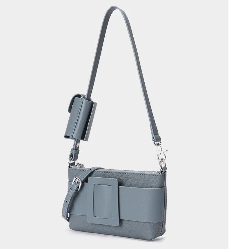 Gray handbag with a strap on a light gray background