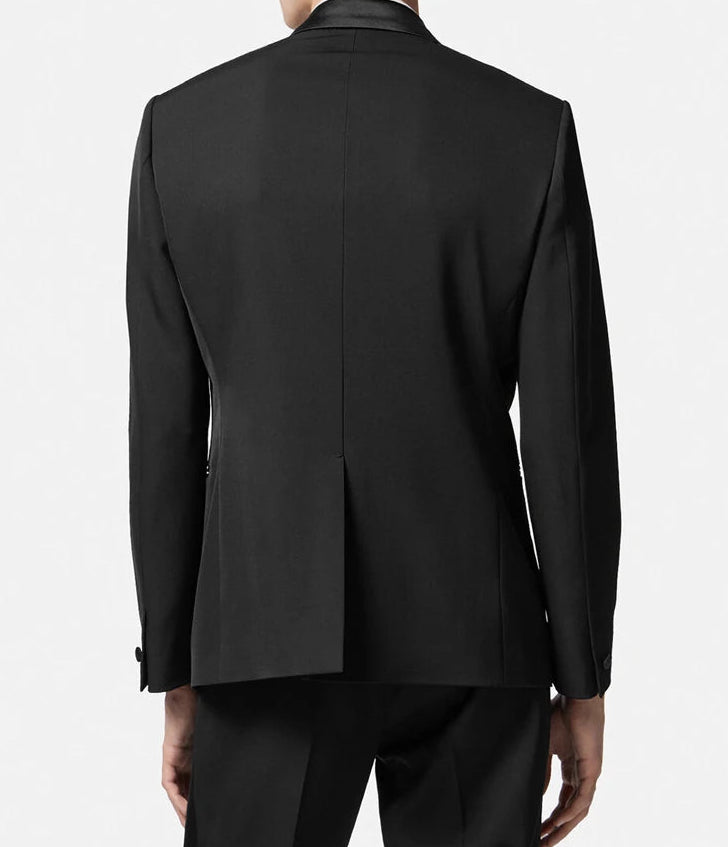 Black suit jacket worn by a person on a white background
