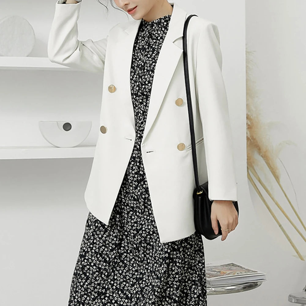 White women’s blazer featuring gold buttons and a turn-down collar front