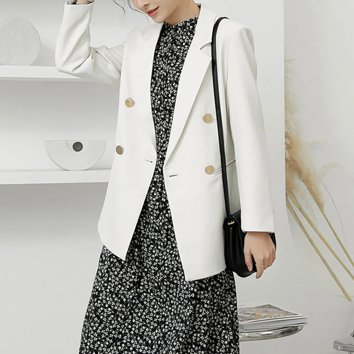 White women’s blazer featuring gold buttons and a turn-down collar front