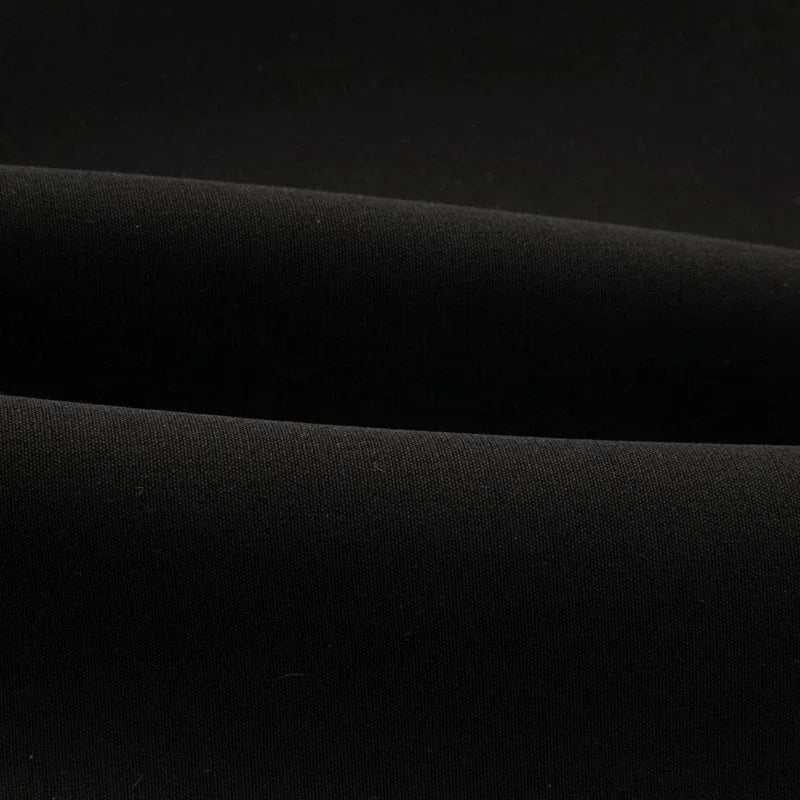 Black waistcoat fabric close-up with smooth woven texture