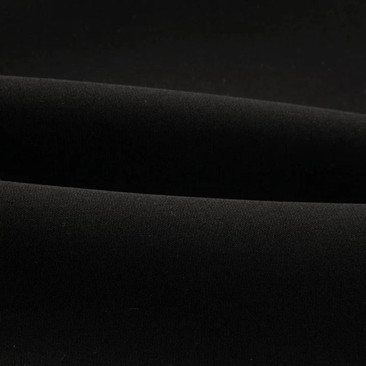 Black waistcoat fabric close-up with smooth woven texture
