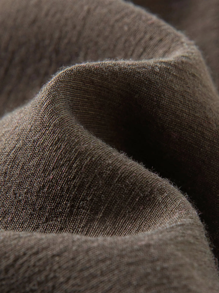 Close-up of dark brown woven linen-blend fabric texture, soft heathered finish