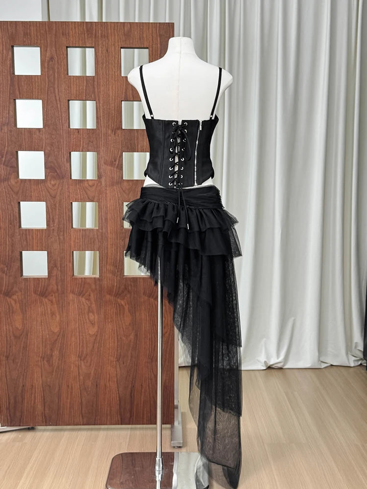 Black lace-up corset top with asymmetrical layered tulle maxi skirt on a mannequin