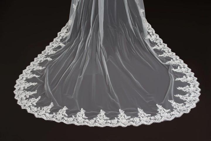 Long sheer veil with scalloped lace border along the hem, gathered at top