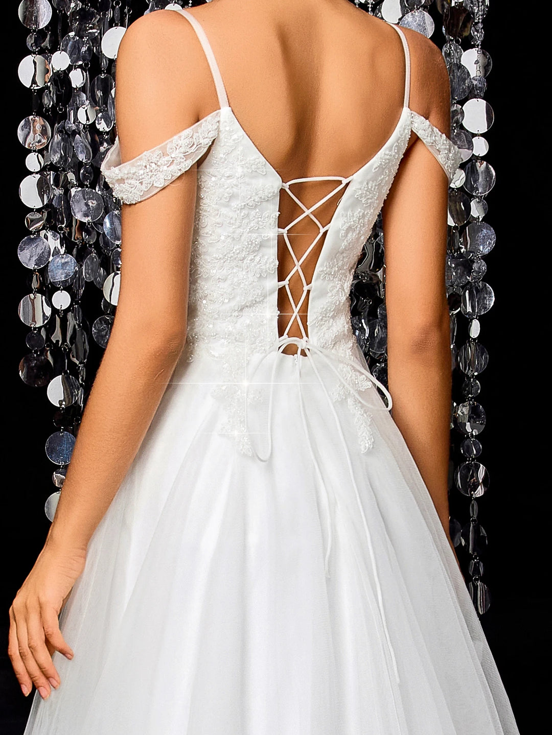 White bridal gown back with crisscross lace-up straps and off-shoulder beaded accents