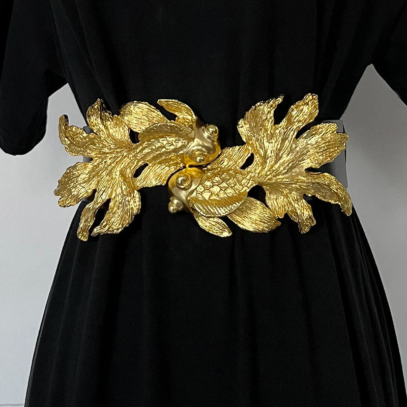 Women’s waist belt with gold fish buckle on a black elastic strap