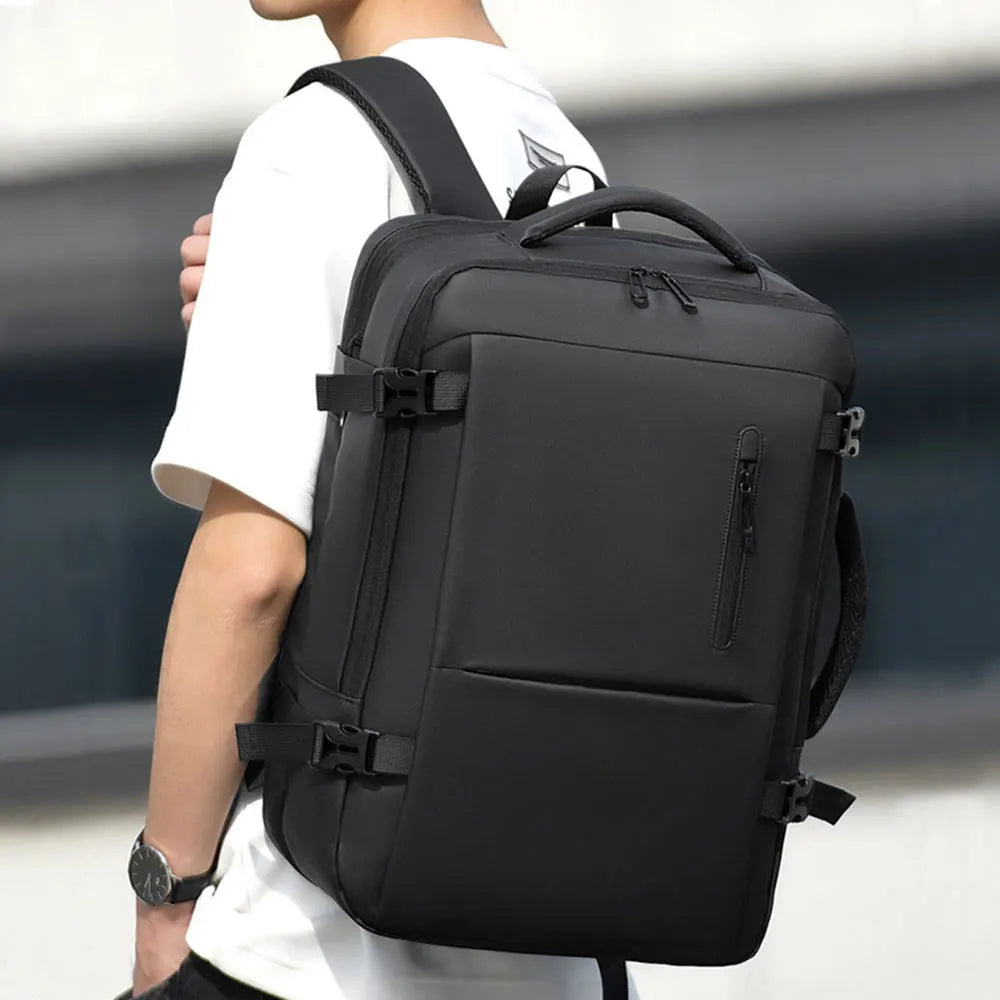 Black men’s travel backpack worn on the shoulder, with front zip pocket and straps