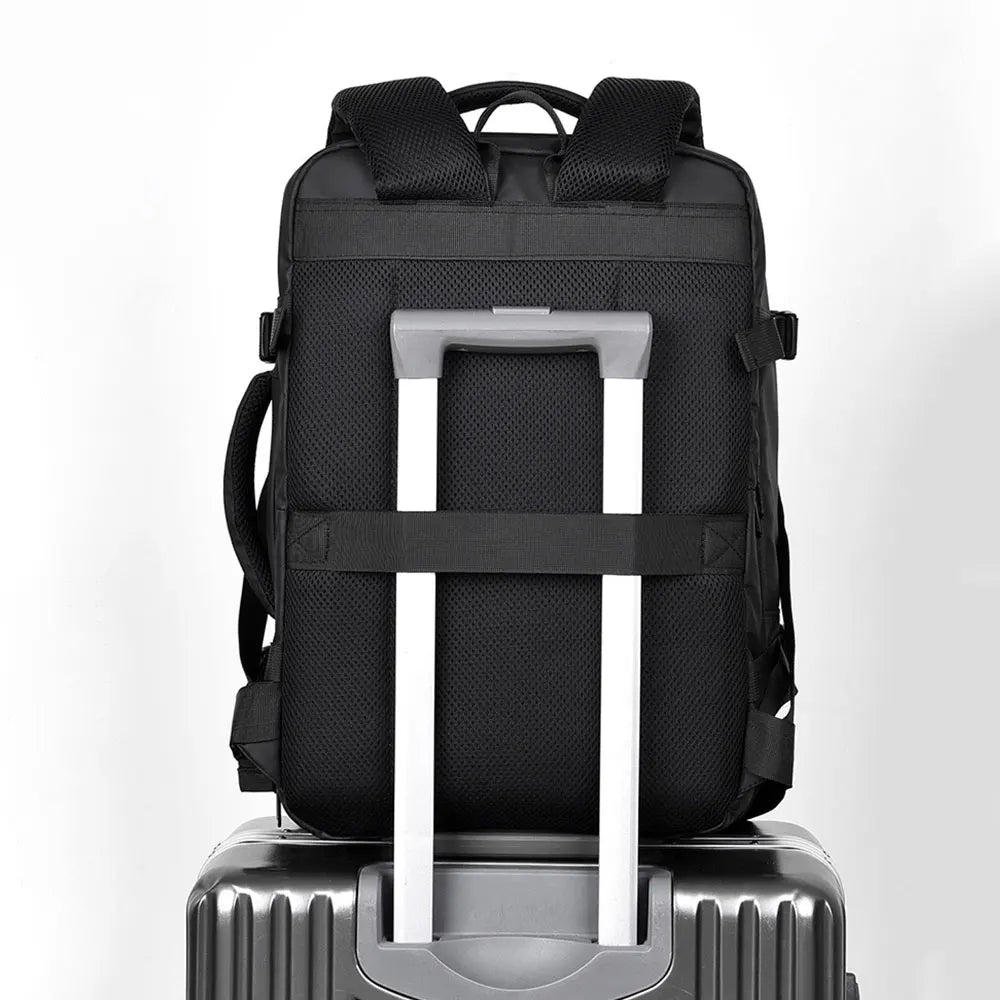 Black travel backpack with reinforced handle and back luggage pass-through sleeve