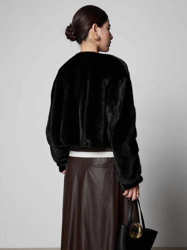 Black women's short mink fur coat, back view with cropped hem