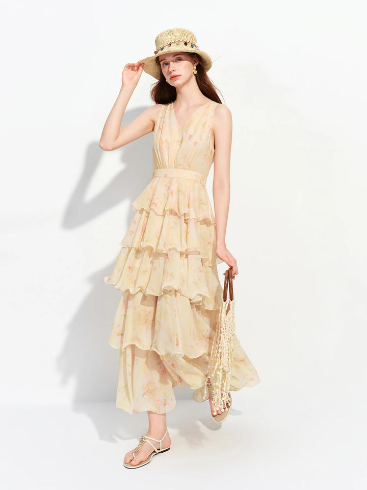 Light yellow sleeveless tiered ruffle maxi dress with fitted waist and tiered hem