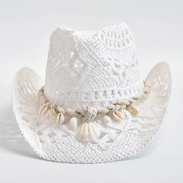 White woven hat with shell embellishments on a light gray background