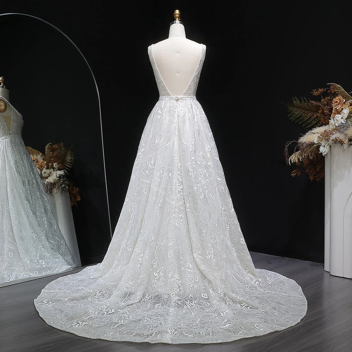 Off-white lace bridal gown on mannequin with full skirt and decorative floral texture