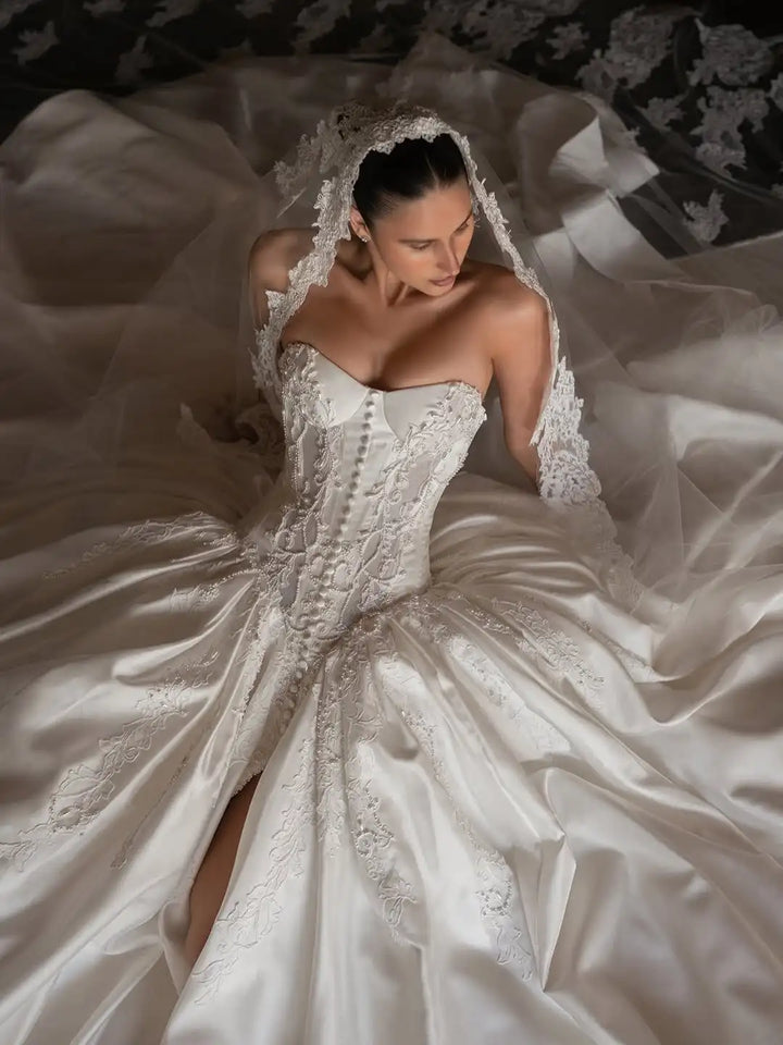 Ivory satin bridal corset gown with lace bodice, sweetheart neckline, and high slit