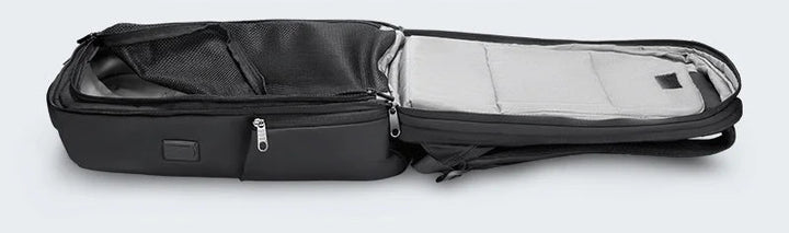 Black expandable backpack showing main compartment open for laptop storage