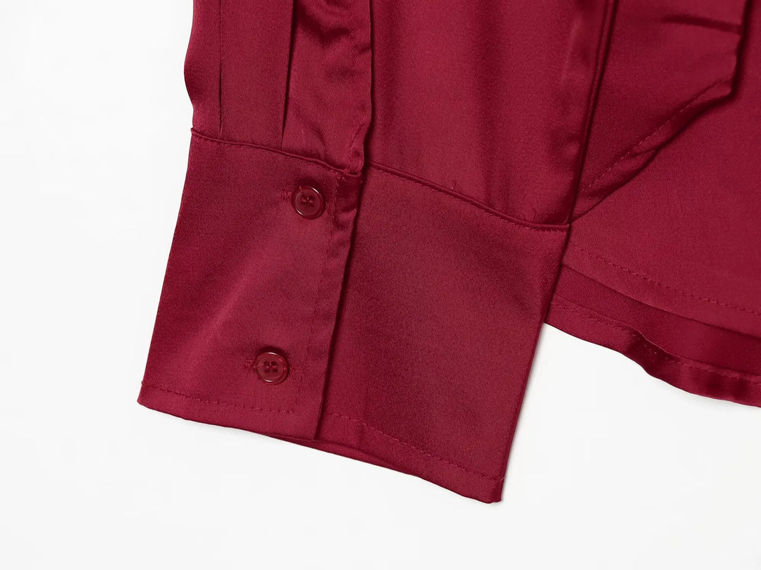 Red satin blouse cuff with two-button placket detail