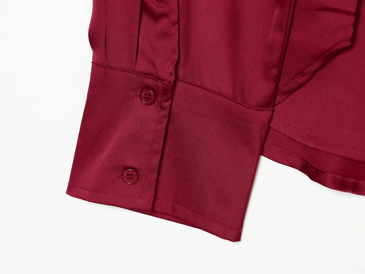Red satin blouse cuff with two-button placket detail