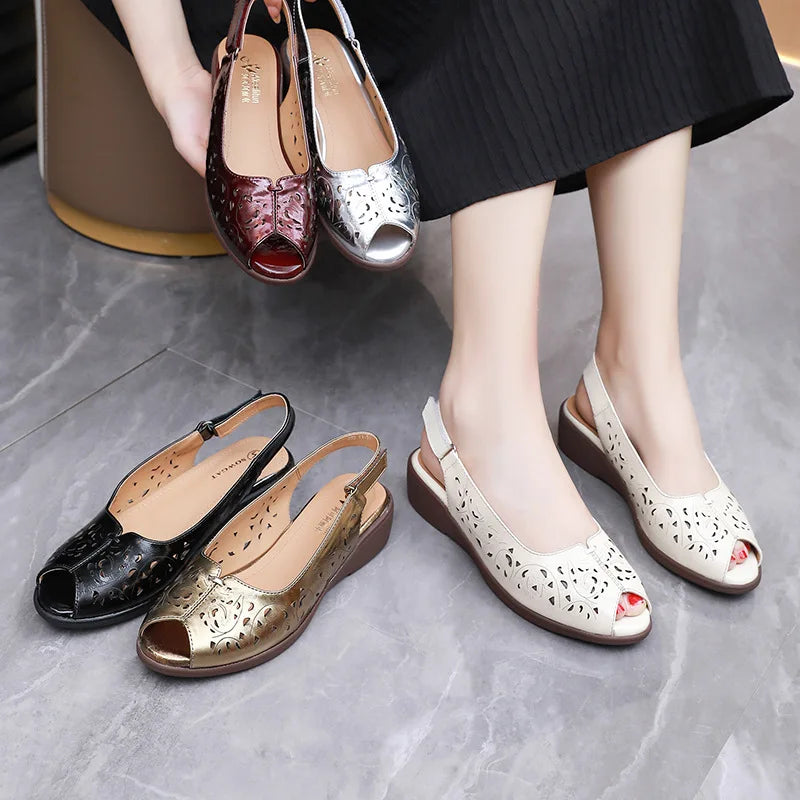 Set of women’s open-toe leather sandals in gold, black, and maroon on low wedges