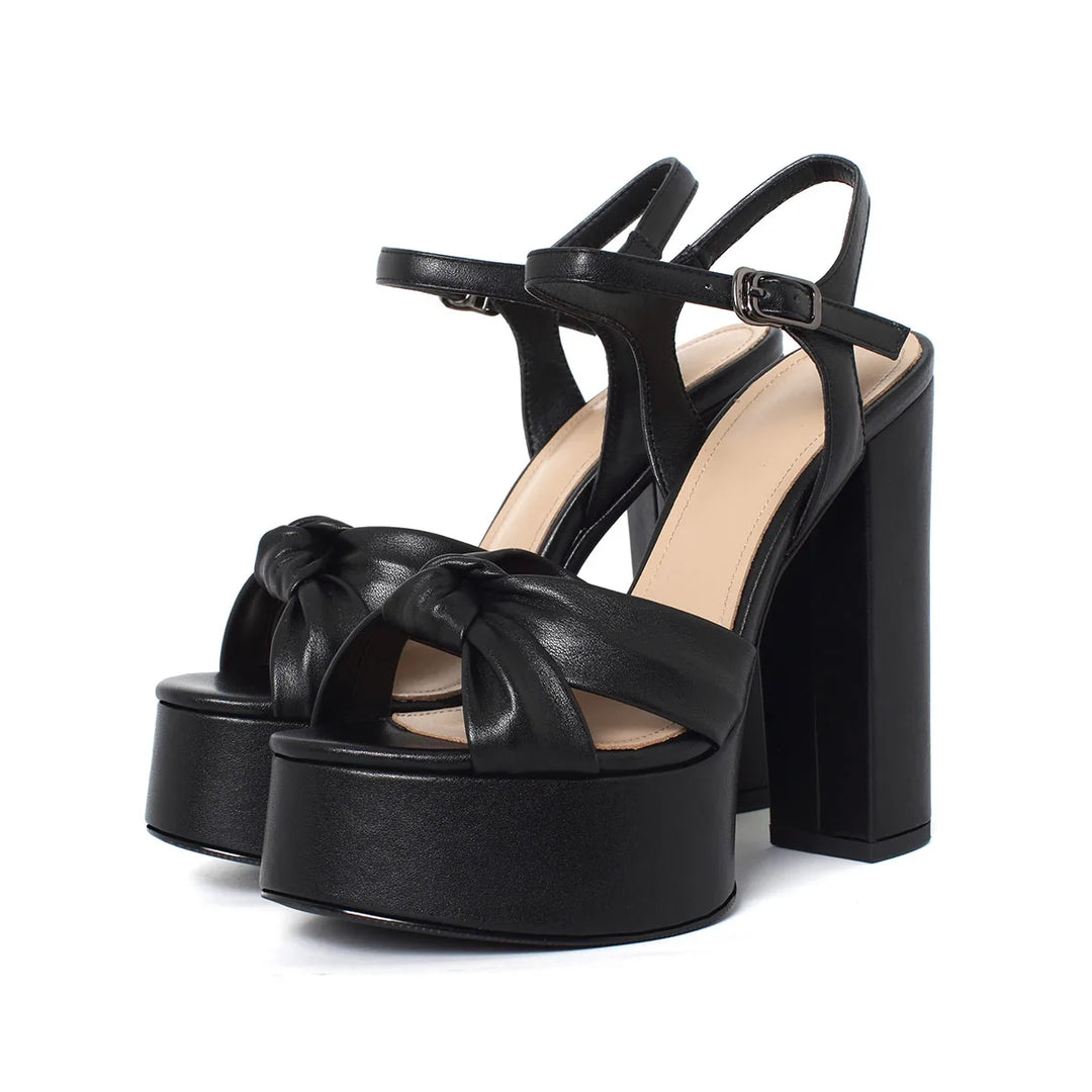 Black platform block-heel sandal with knotted front strap and ankle buckle