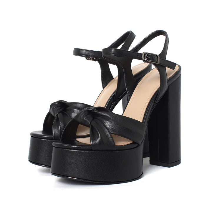 Black platform block-heel sandal with knotted front strap and ankle buckle