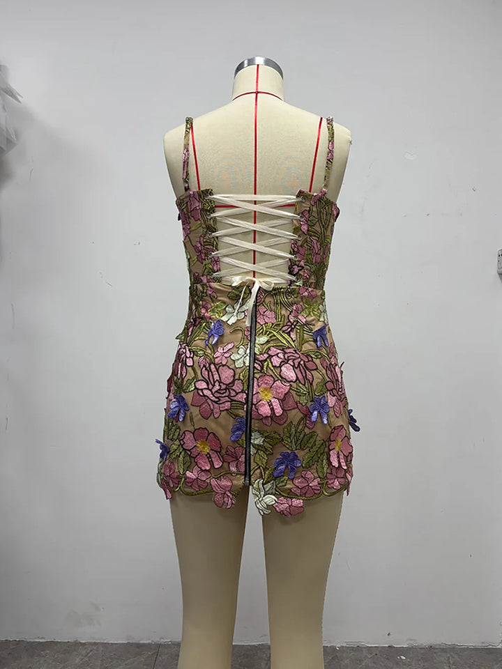 Back view of pink floral embroidered mini gown with lace-up corset detail