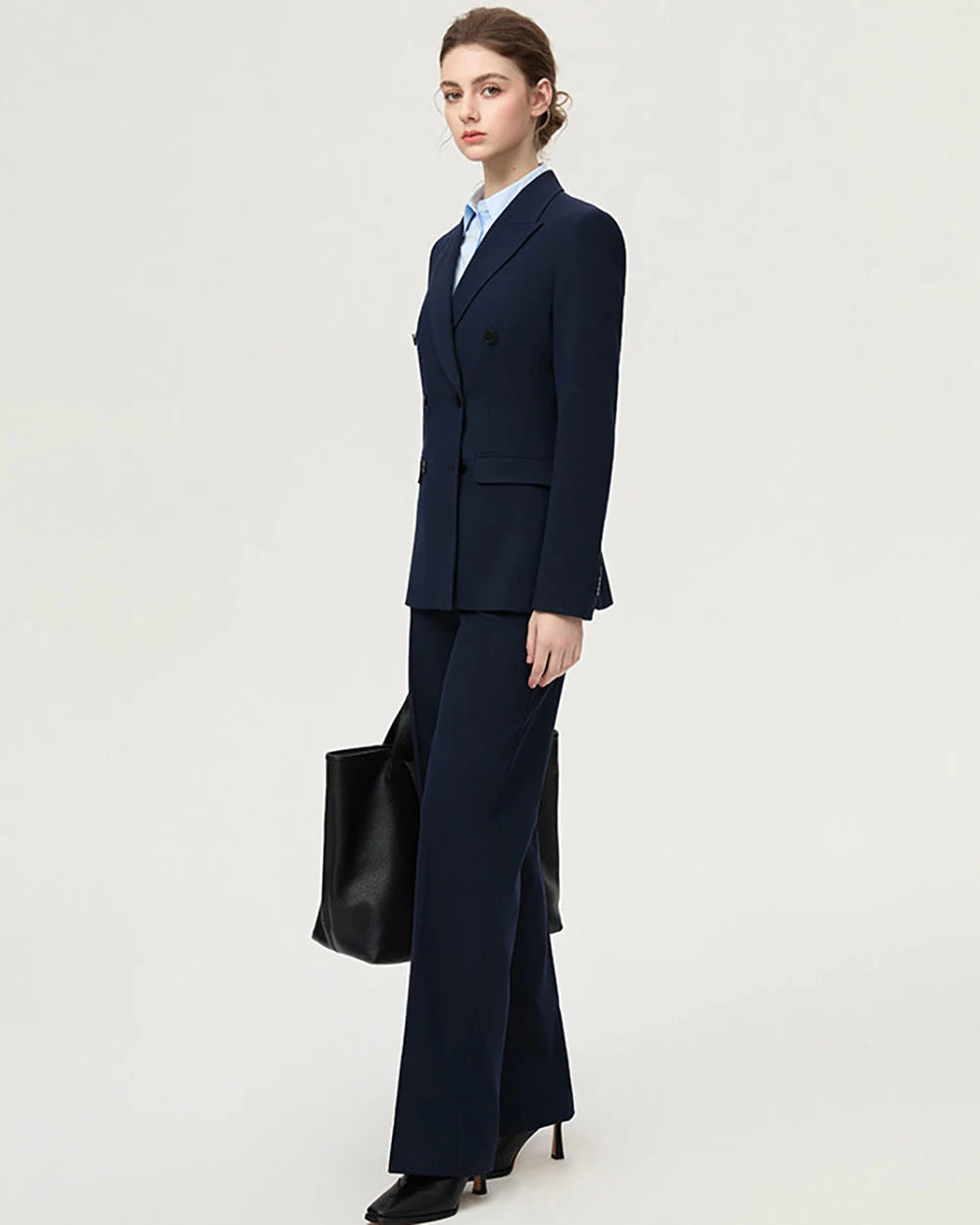 Women’s navy two-piece blazer suit with tailored blazer and straight-leg trousers, side view