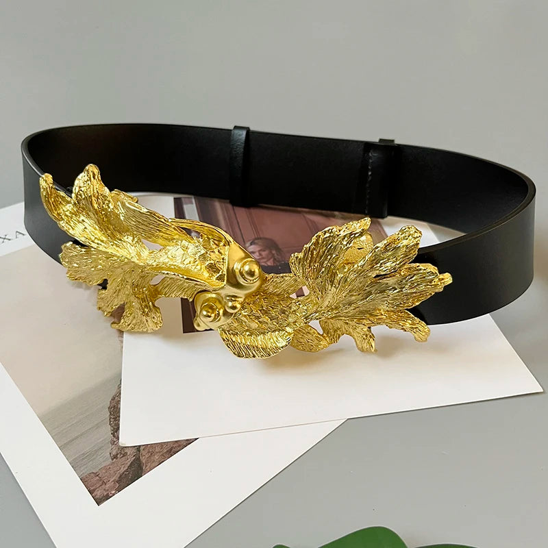 Black leather-look women’s waist belt with gold fish buckle, side view