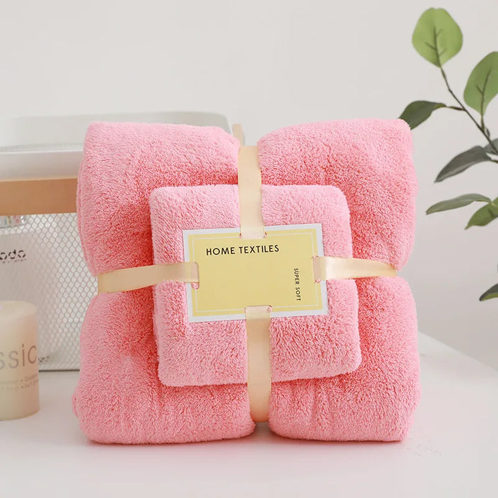 Pink plush bath towel set, four folded towels neatly wrapped with ribbon