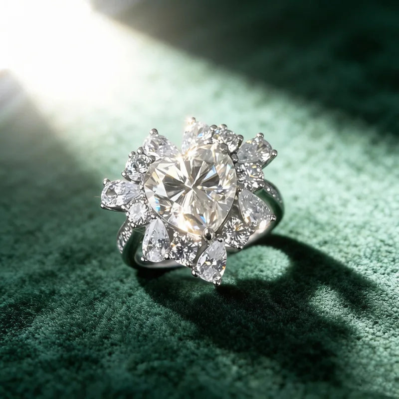 Sterling silver ring with large round center and surrounding round and pear stones.