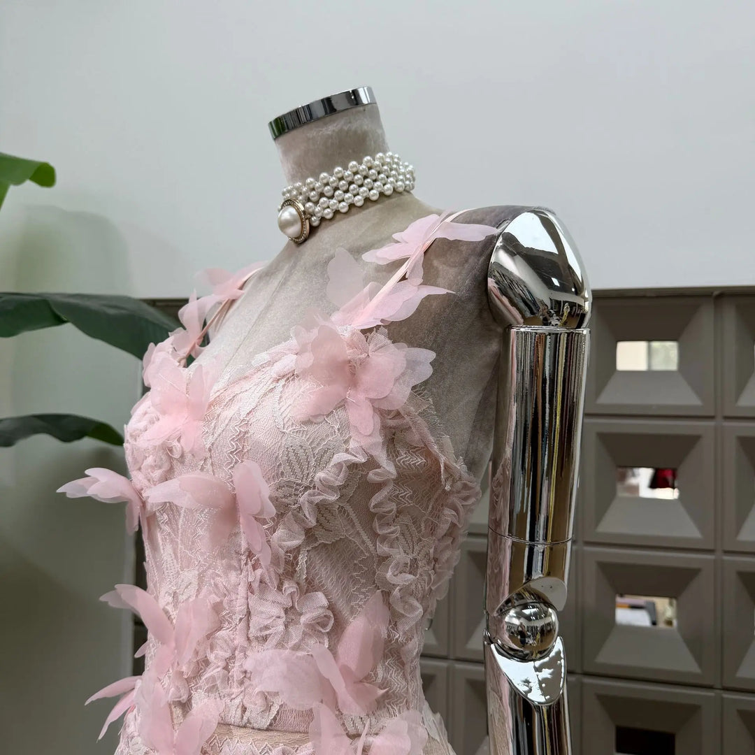 Pink lace corset mini dress with 3D floral appliques and bow-like butterfly shoulder details