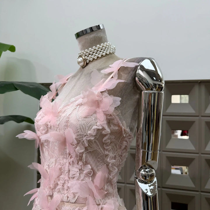 Pink lace corset mini dress with 3D floral appliques and bow-like butterfly shoulder details