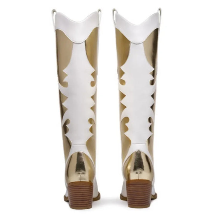 Pair of white knee-high boots with pointed toes, gold accents, floral cutouts, block heels