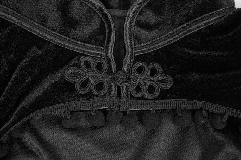 Close-up of black velvet crop top with embroidered lace trim and scalloped edge