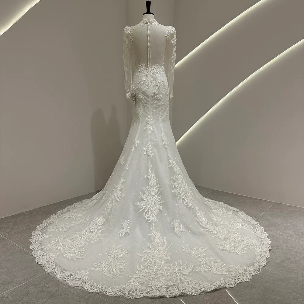 Ivory white bridal gown with puff sleeves, lace appliqué, and long train