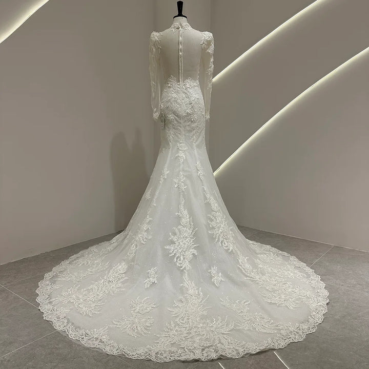 Ivory white bridal gown with puff sleeves, lace appliqué, and long train