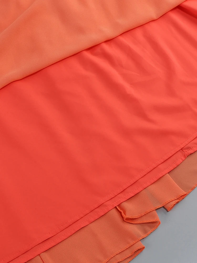 Orange dress hem with ruffled trim and layered skirt panels